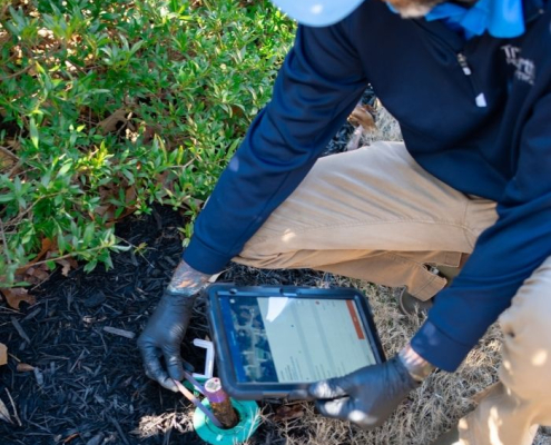 TruNorth Pest Control technician treating a yard in Jacksonville FL for pest control