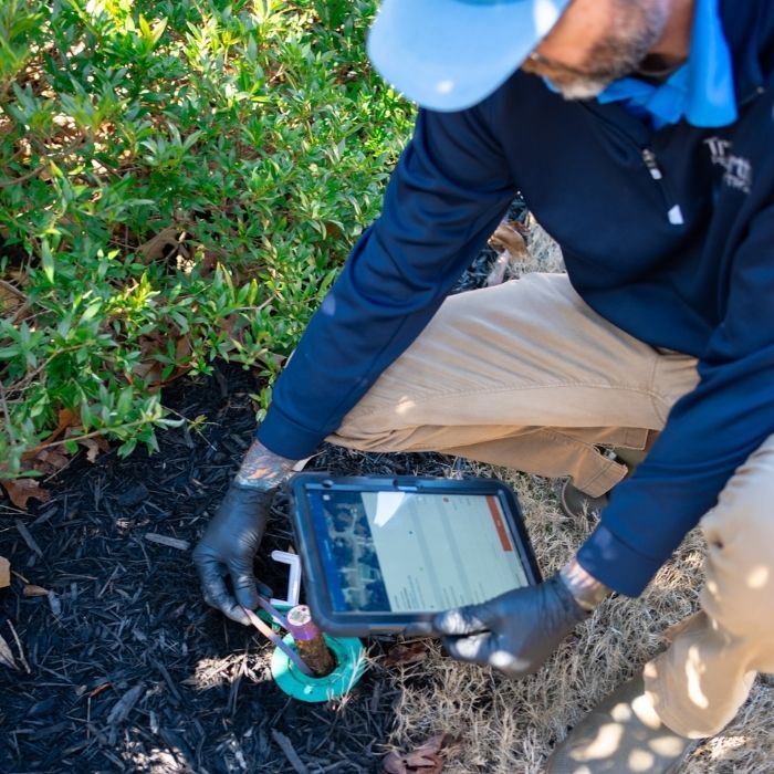 TruNorth Pest Control technician treating a yard in Jacksonville FL for pest control